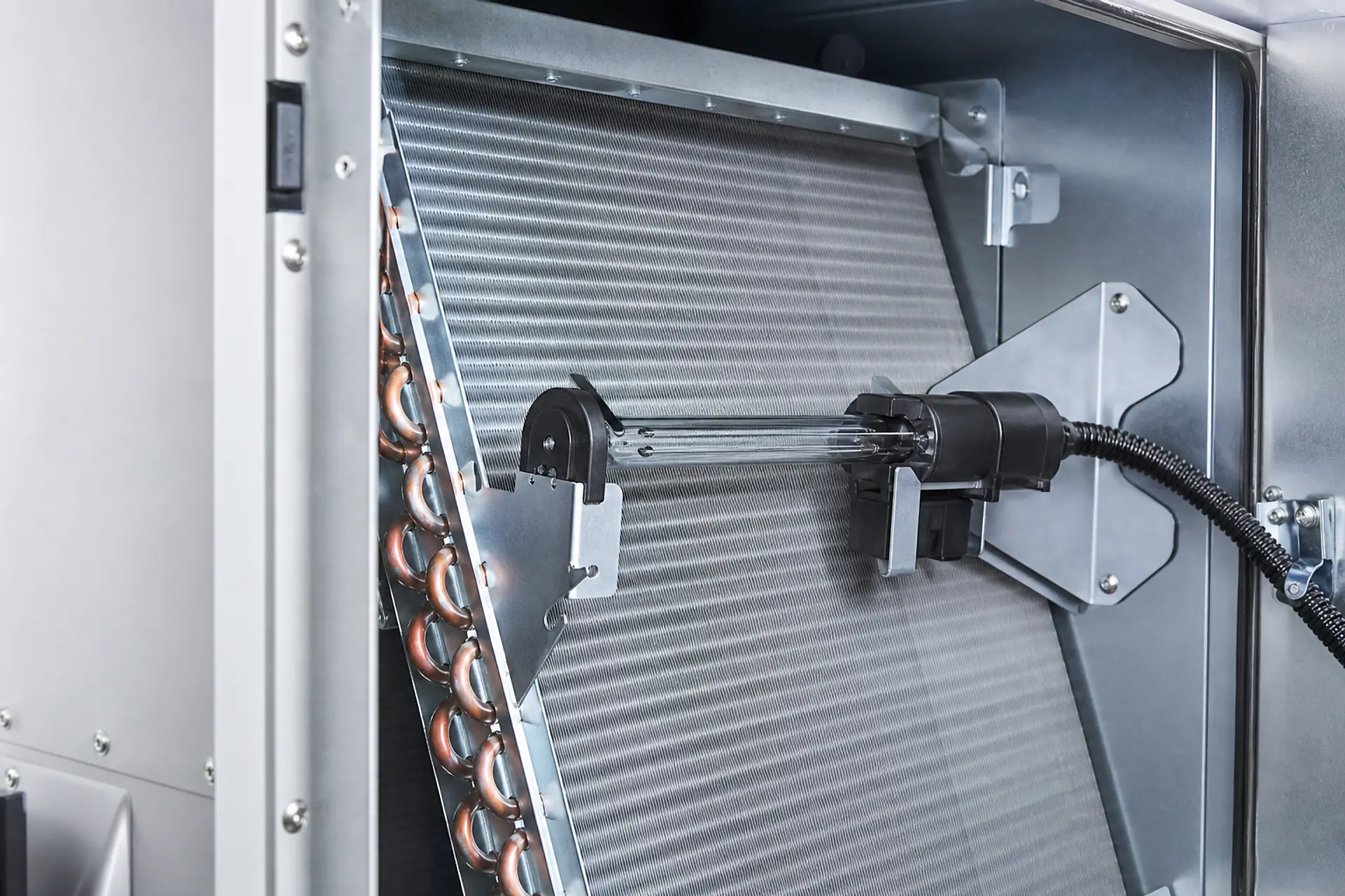 Conceptual close-up of an unlit UV-C assembly installed near an HVAC coil